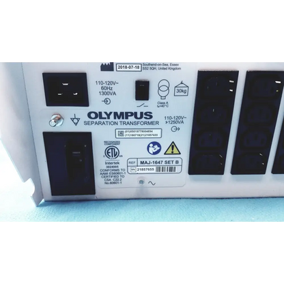 White olympus separation transformer with black power outlets and certification labels.