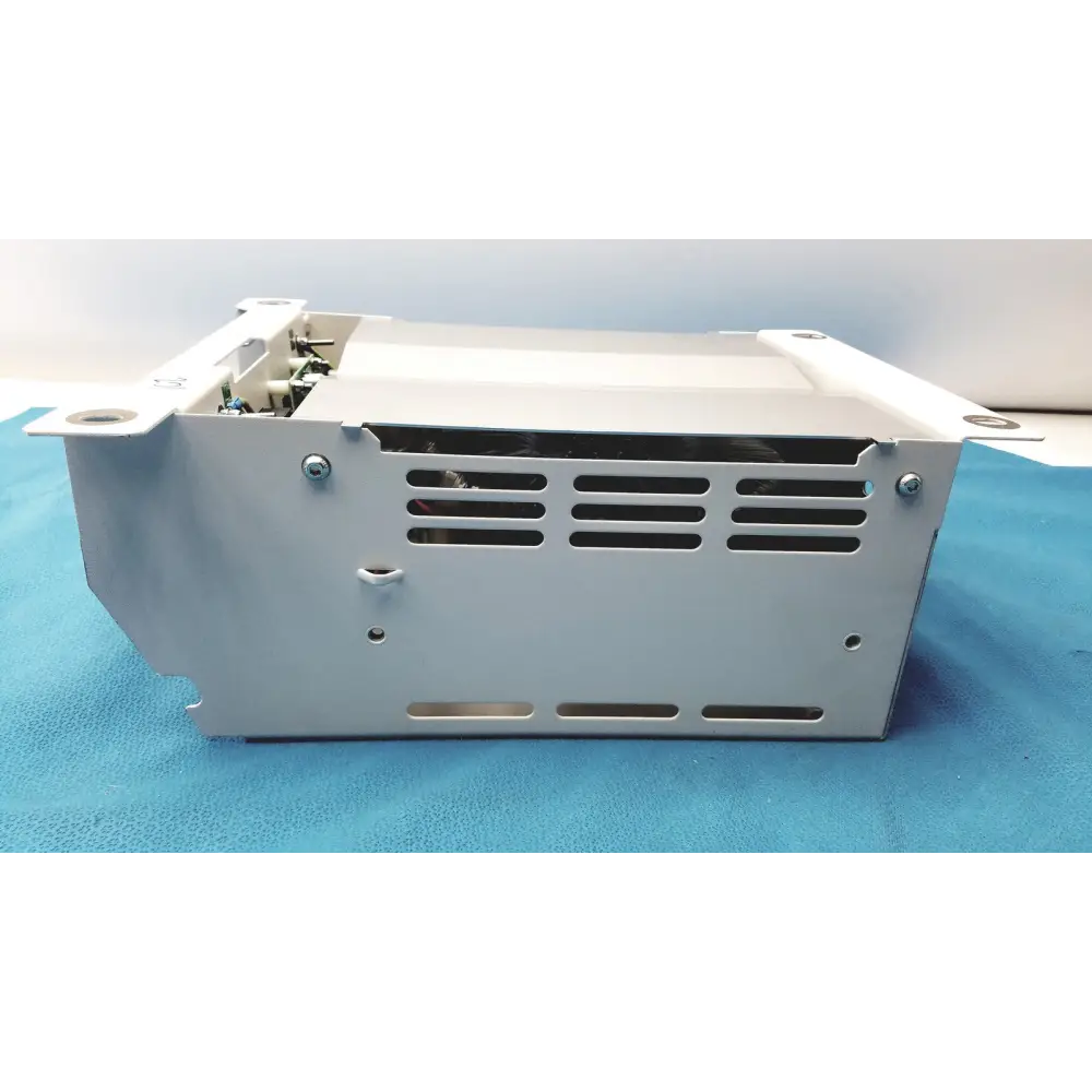 Silver metallic industrial power supply unit with a rectangular chassis, ventilation slots on the side panel, and mounting brackets at each corner.