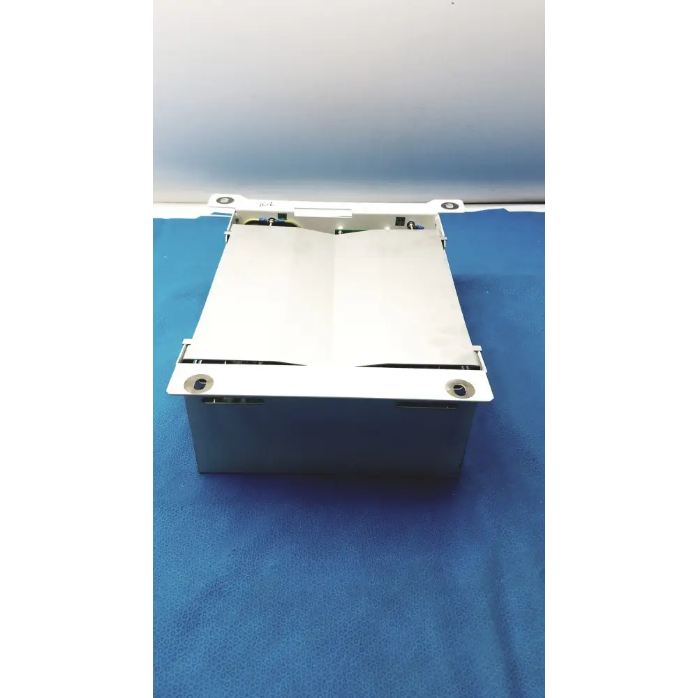 White metal cash register drawer with a hinged lid and visible internal components.