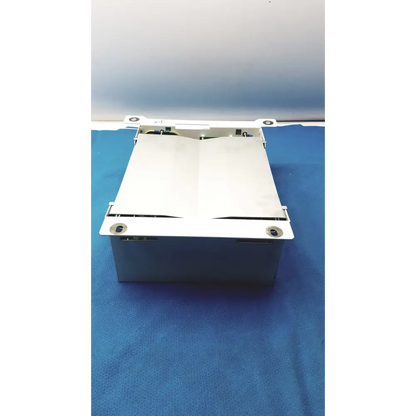 White metal cash register drawer with a hinged lid and visible internal components.