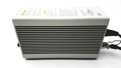 Gray rectangular Olympus TH4-100 100W 120V halogen power supply unit with ribbed front panel and black cables extending from side