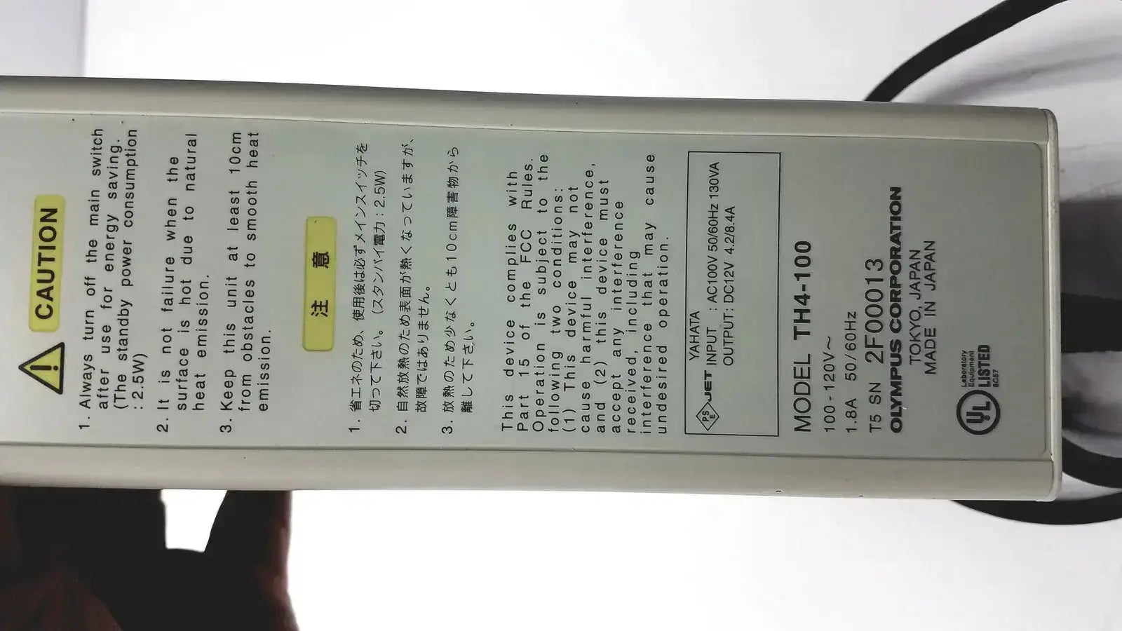 Olympus th4-100 halogen power supply with beige casing and printed specifications for 100w 120v halogen power use