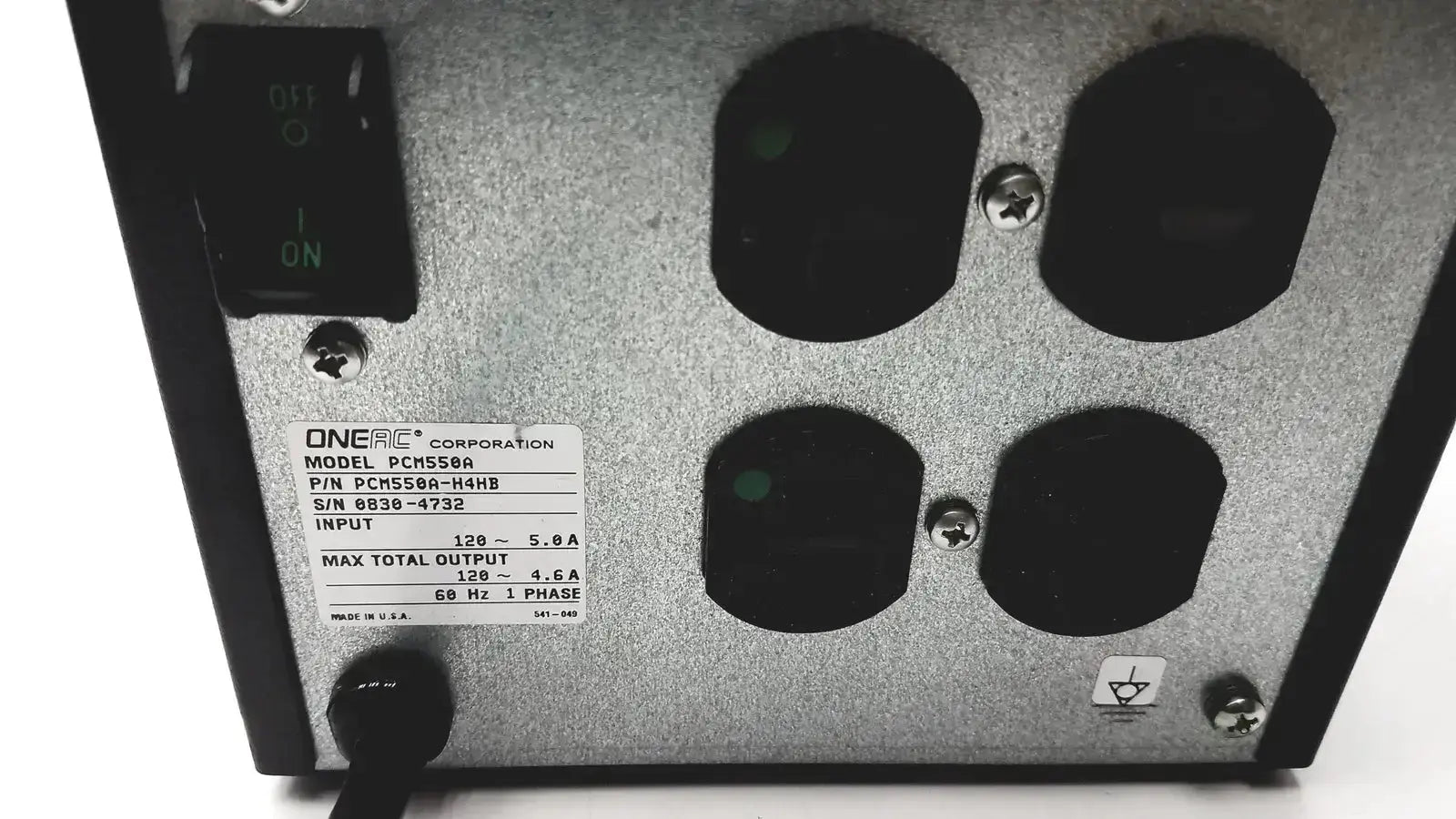 Silver metallic conditioned power pcm550a unit with black input ports and green-lit switch labeled oneac corporation model pcms58a