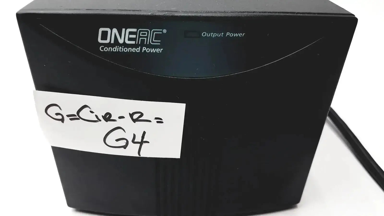 Black oneac conditioned power pcm550a surge protector with handwritten label on front for power conditioning