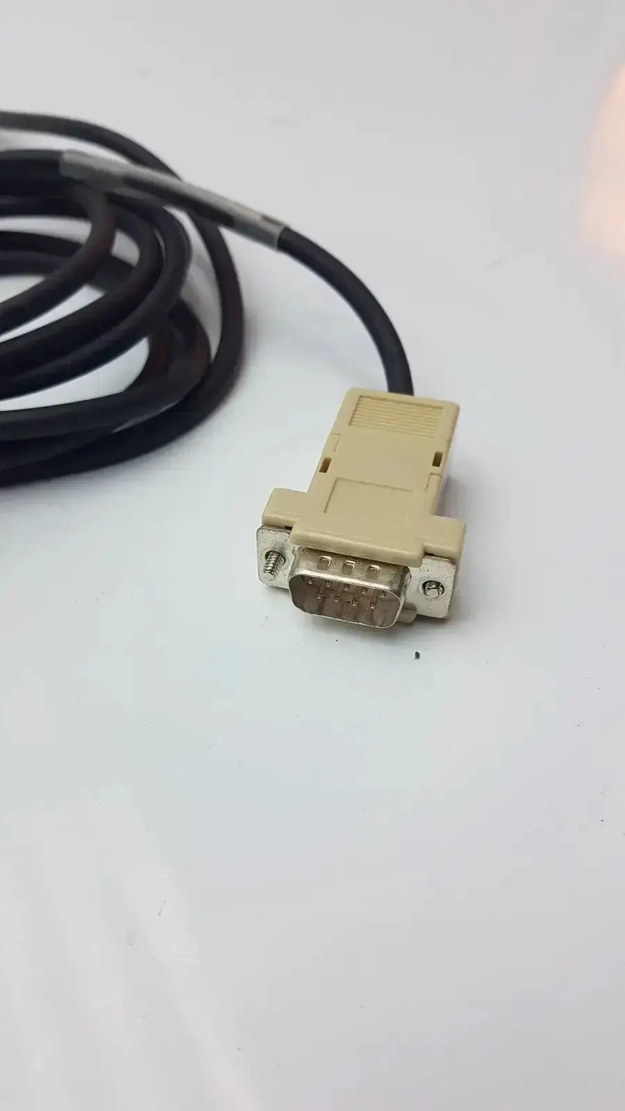 Beige db9 serial cable connector with black coiled cord for opticon barcode scanner used medical equipment for sale