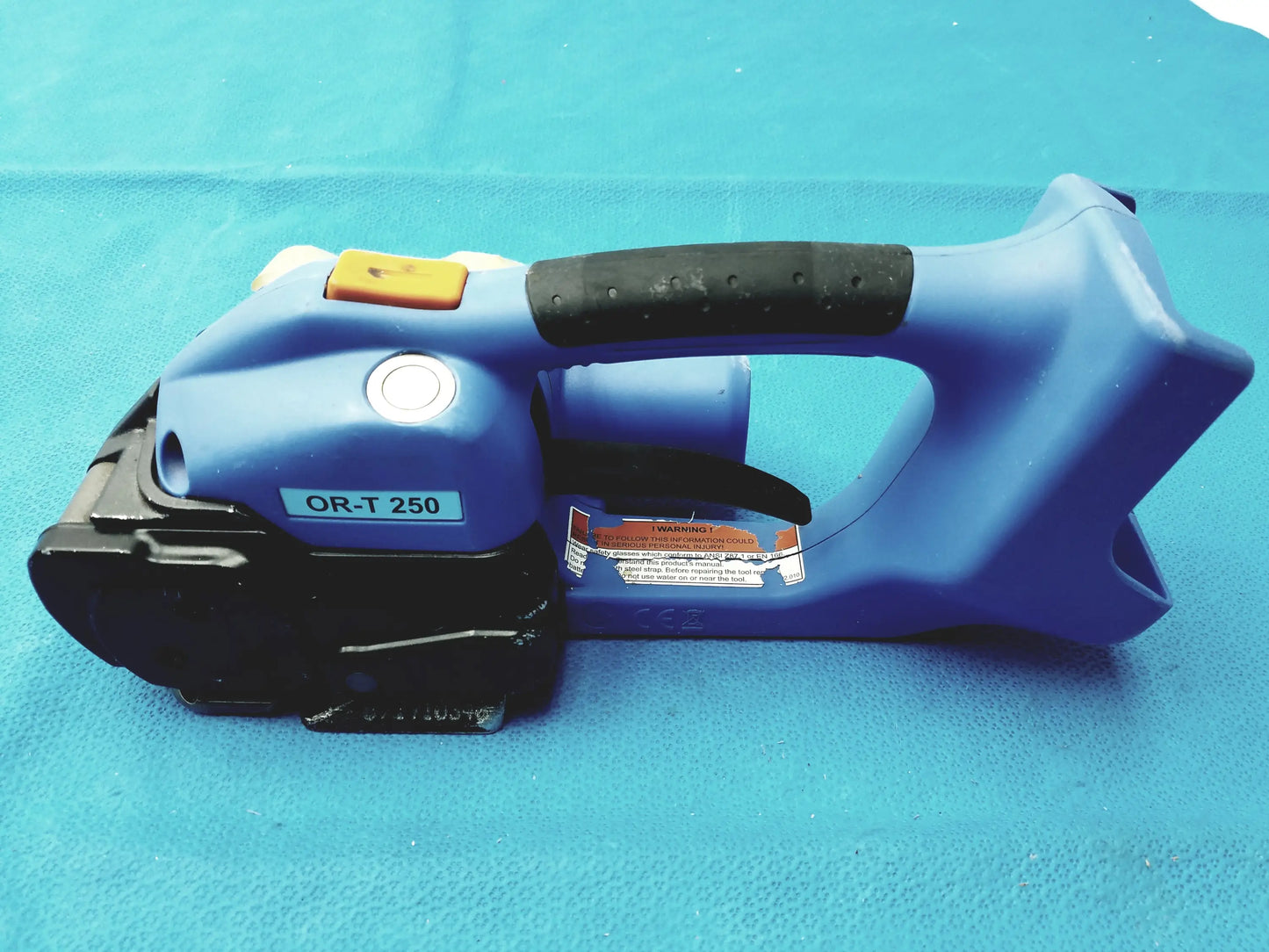 Blue plastic and black rubber-handled orgapack OR-T 250 battery operated cordless banding machine for reuse medical equipment