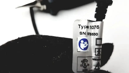 White rectangular label with black text and blue icon on dark otocam 973530 video otoscope for hearing care used medical equipment for sale