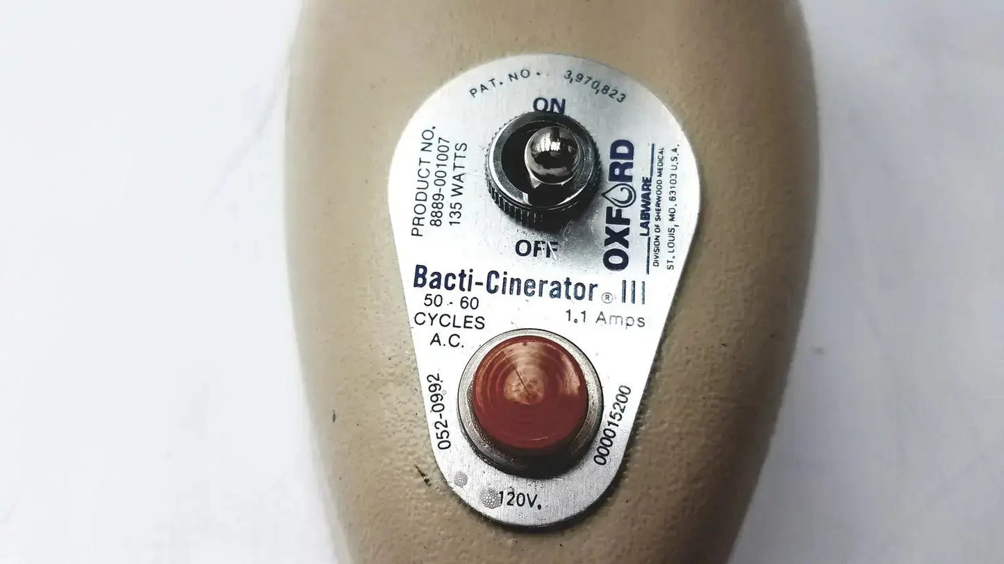Silver labeled control panel on beige oxford labware bacti-cinerator iii sterilizer for laboratory use