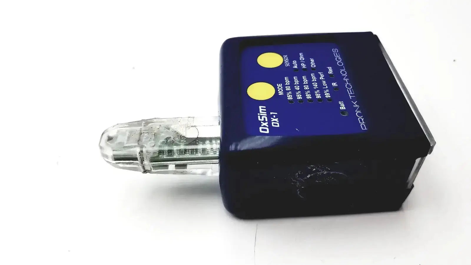 Black rectangular dx-sim dx-1 pulse oximeter simulator with transparent plastic attachment and yellow indicator lights