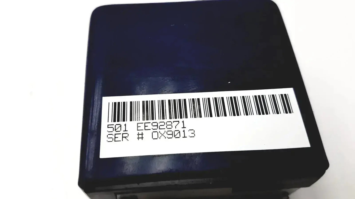 Black rectangular oxsim OX-1 pulse oximeter simulator with white barcode label showing serial numbers on the back side