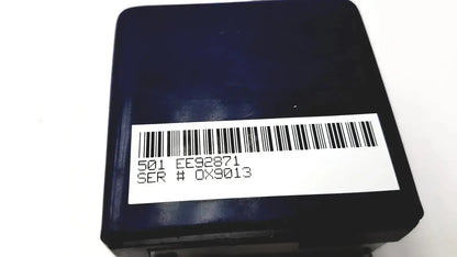 Black rectangular oxsim OX-1 pulse oximeter simulator with white barcode label showing serial numbers on the back side