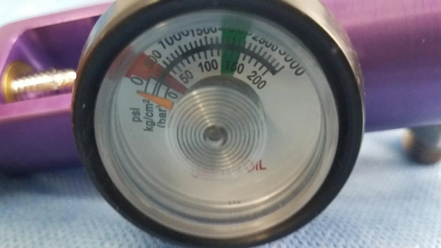 A circular metallic pressure gauge with black rim and multicolor psi markings for medical gas oxygen regulator
