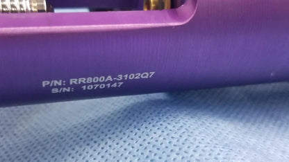 Purple cylindrical oxygen regulator with engraved part and serial numbers for precise medical gas flow control