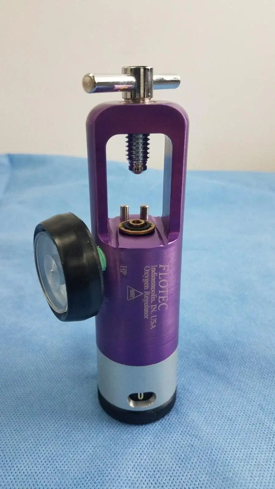 Purple and silver flotec oxygen regulator with black pressure gauge medical gas flow control device for medical equipment