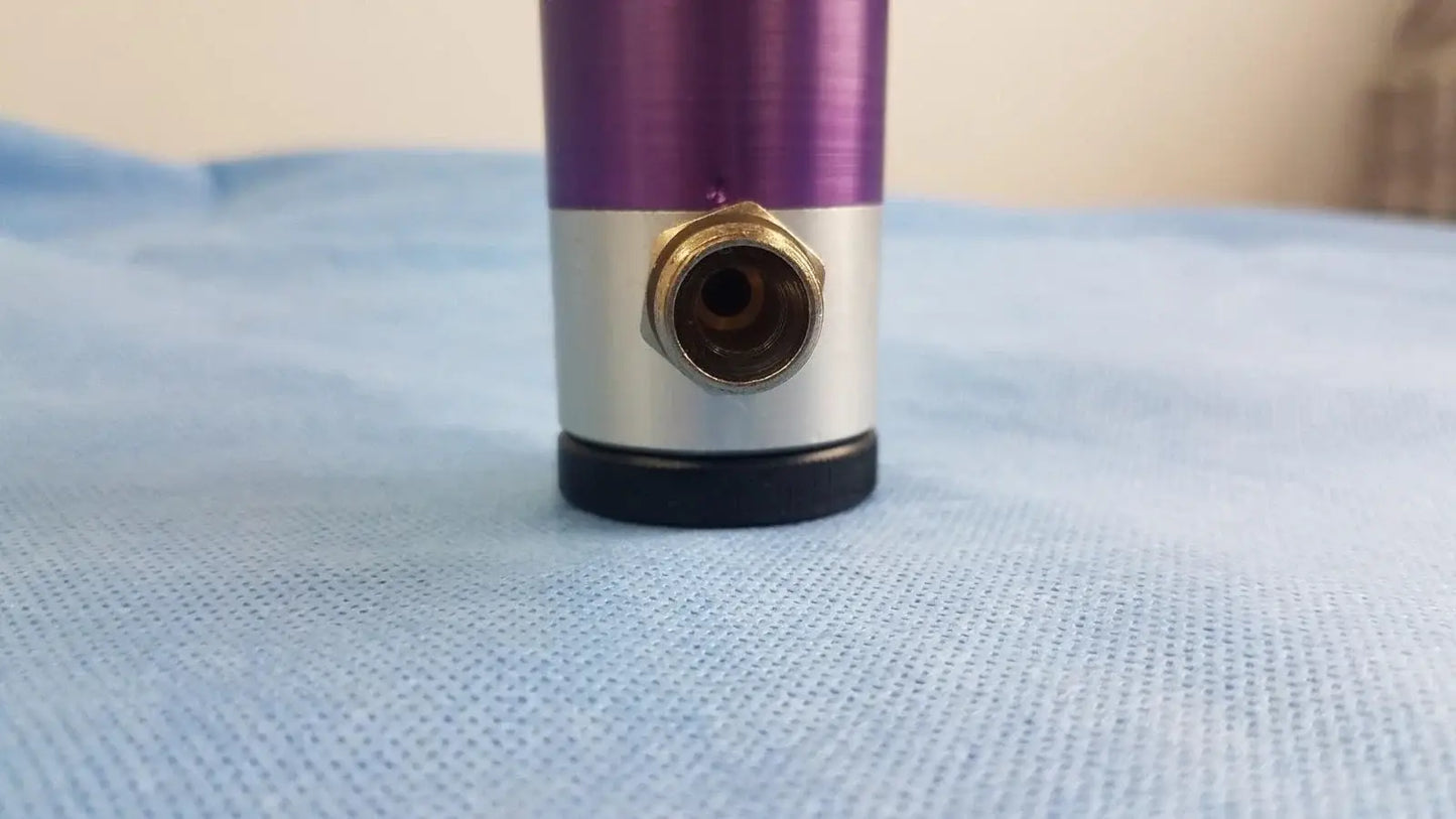 Purple and silver cylindrical oxygen regulator with brass threaded port for precise medical gas flow control in medical equipment