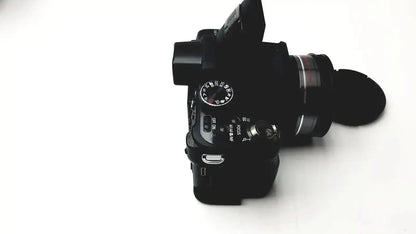 Black panasonic model dmc-fz35 digital camera with lens cap and manual control dials including lumix battery charger