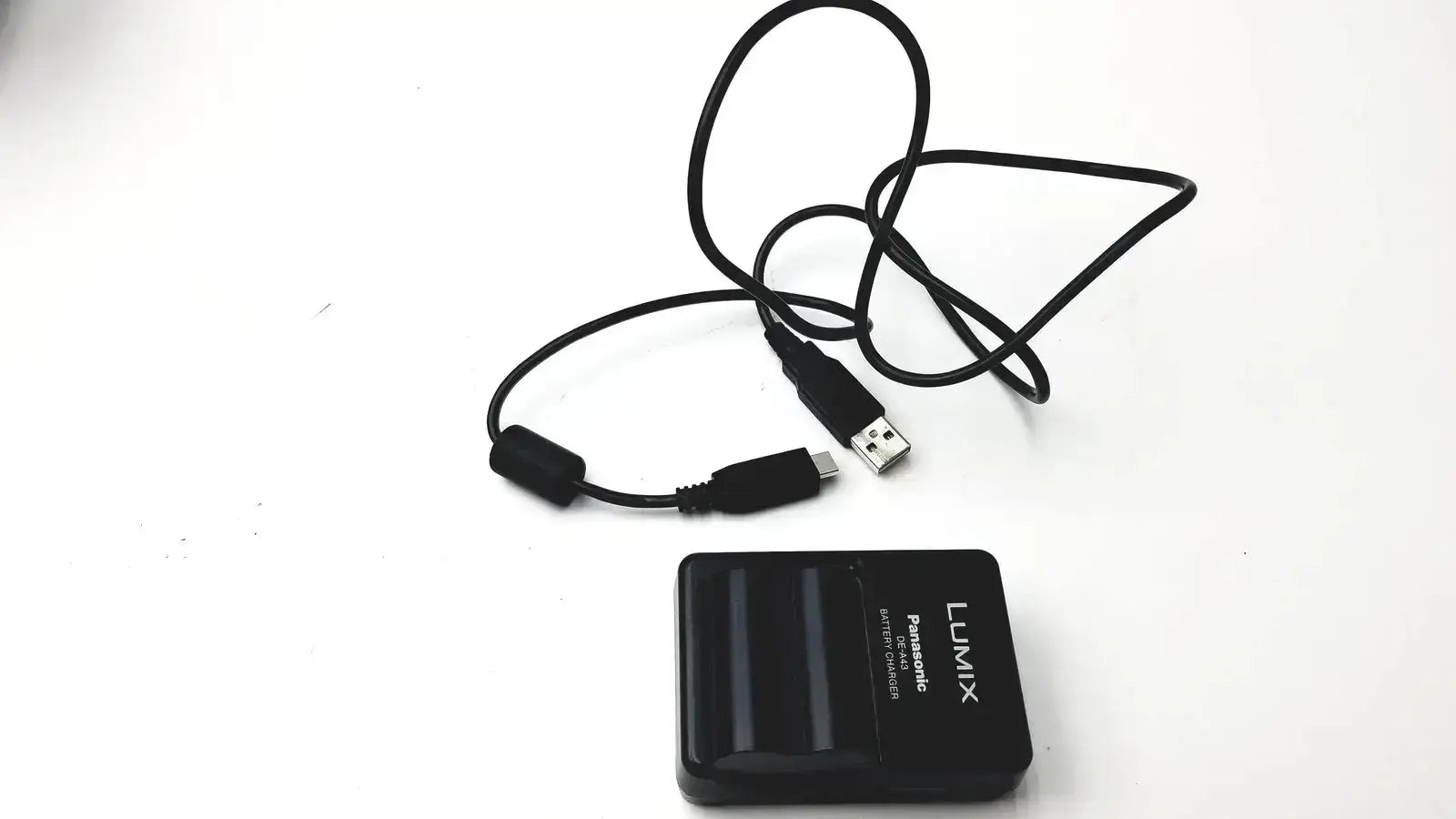 Black Panasonic Lumix DE-A43 battery charger with coiled USB cable for Panasonic model DMC-FZ35 digital camera