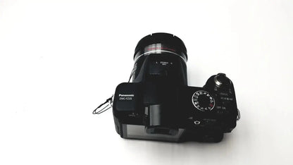 Black panasonic model dmc-fz35 digital camera with textured grip and control dials featuring lumix de-a43 charger