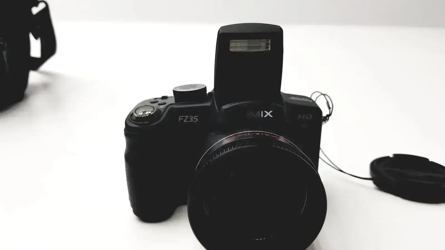 Black fujifilm finepix fz35 digital camera with built-in flash and lens cap near panasonic model dmc-fz35 battery charger