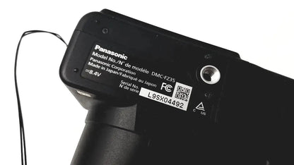 Black panasonic model dmc-fz35 digital camera body with matte finish and printed specifications label visible
