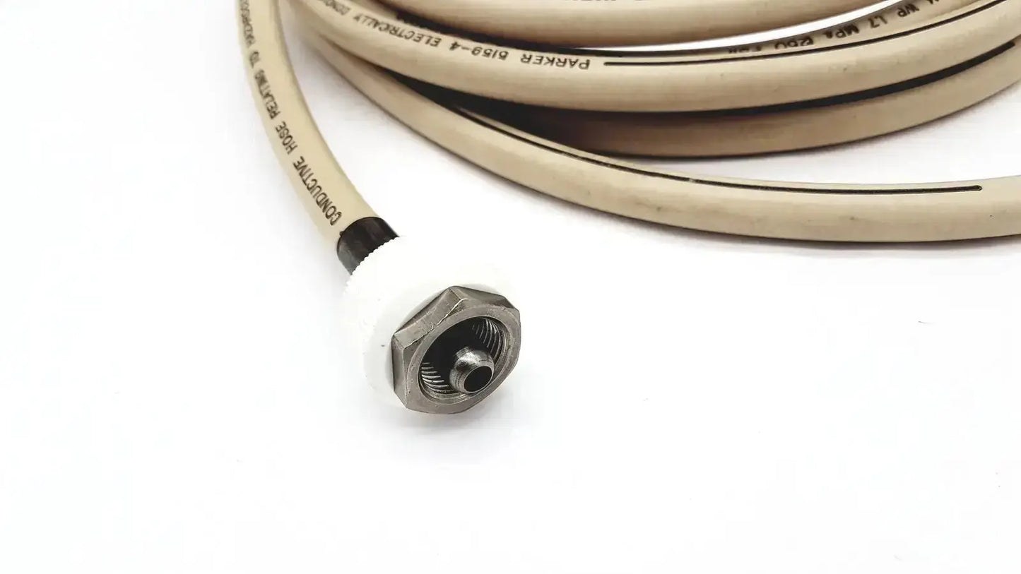 Beige coiled electrically conductive hose with metallic hexagonal connector and black labeling for industrial use