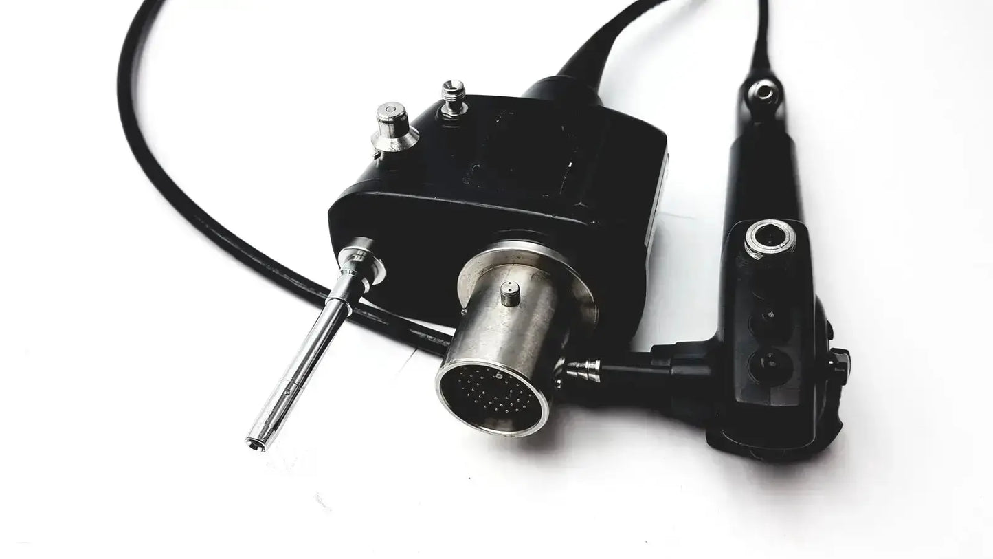 Black and silver pentax eb 1570k bronchoscope endoscopy endoscope with cylindrical lens housing connected by cables to control unit