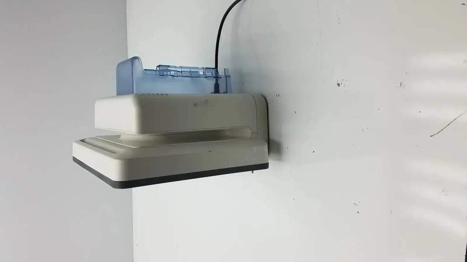 Beige and blue plastic wall-mounted intellivue mx700 bedside patient monitor with black power cord for medical use