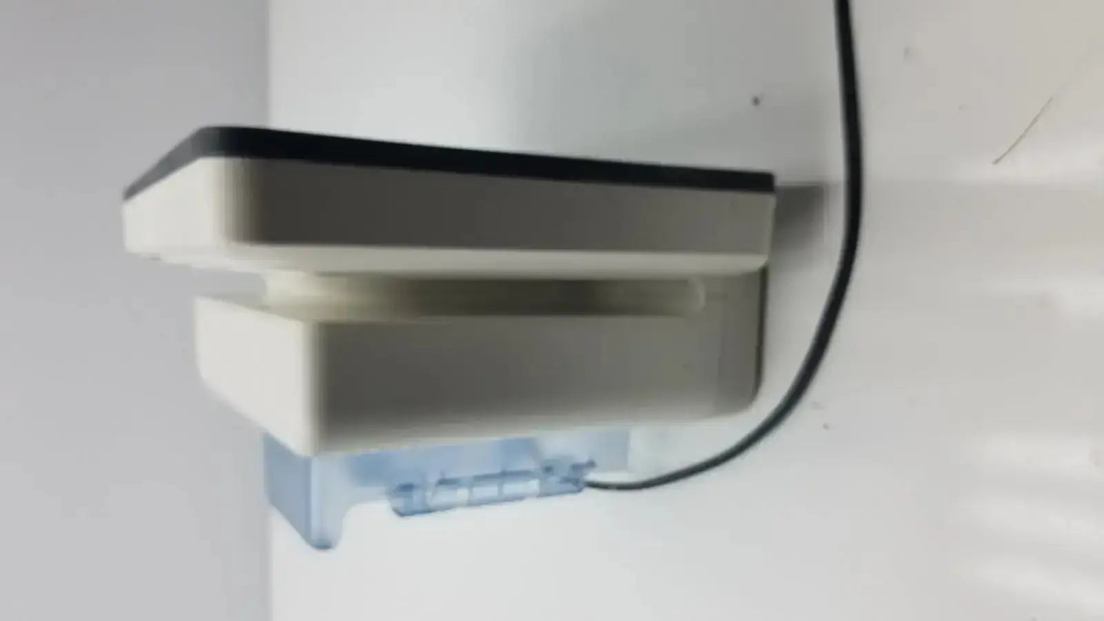 White and black plastic wall-mounted ice maker with water outlet for Philips 865241 IntelliVue MX700 bedside patient monitor