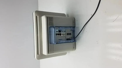 Beige plastic intellivue mx700 bedside patient monitor showing blue internal component and black cable connected