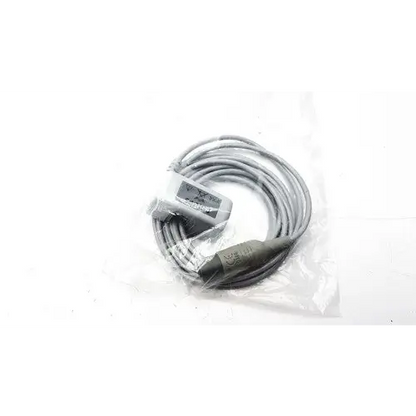 Gray coiled cable with a black connector and a small rectangular label on the housing.