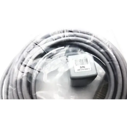 Gray coiled cable with a small gray rectangular connector labeled ’s/n: ub s14 30475’’