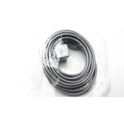 Gray coiled cable with a small rectangular connector at one end, wrapped in clear plastic packaging