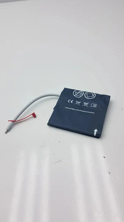 Black rectangular laptop battery with white labeling and gray cable with red connector for Philips easy care adult ref m4555b