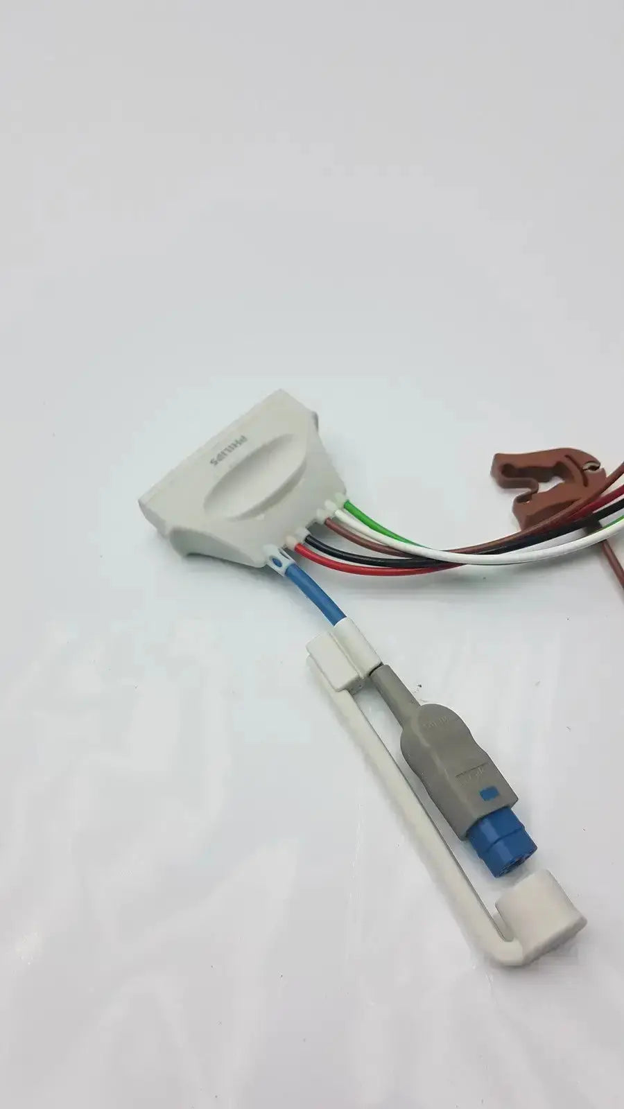 White plastic philips ecg leads grabber with multicolored wires and gray housing for hospital surplus telemetry use