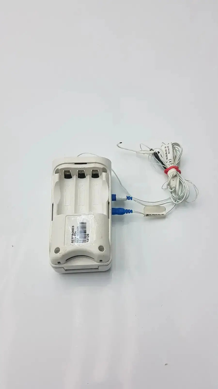 White plastic philips healthcare respiironics aliice pdx battery charger with three slots and attached cables ref 1043941