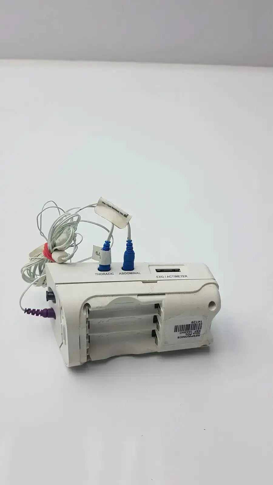 White plastic philips healthcare respiironics aliice pdx medical device with blue gray thoracic and abdominal connectors and barcode