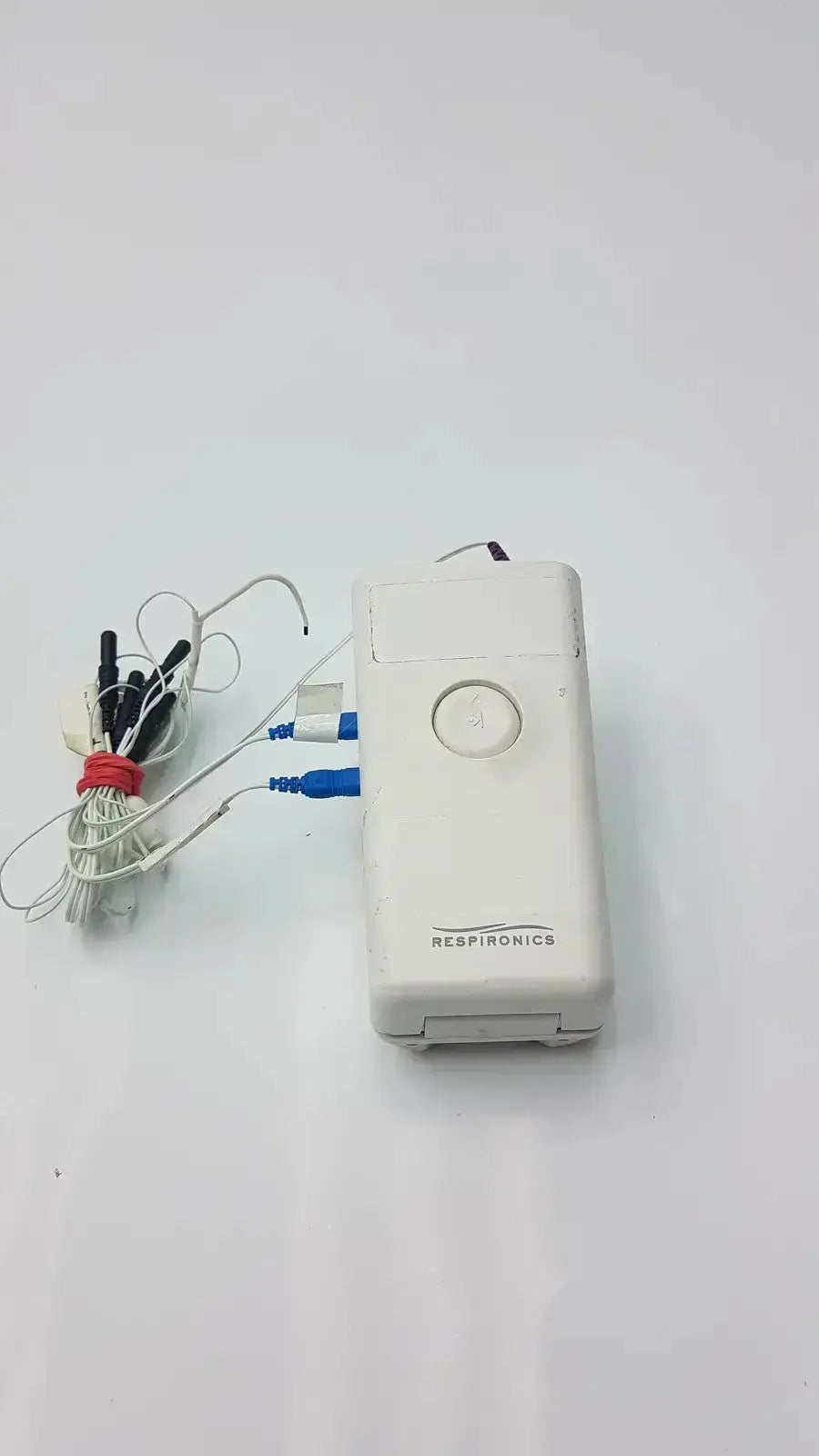 White rectangular philips healthcare respiironics aliice pdx portable oxygen concentrator with circular button and red tied tubing