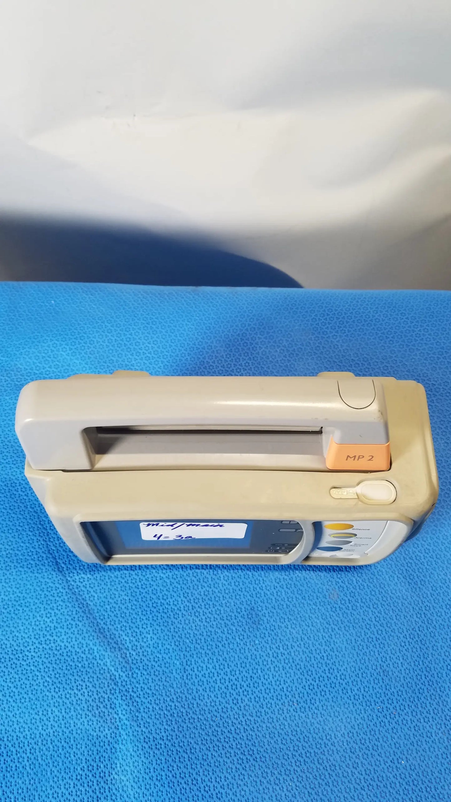 Beige and orange medical infusion pump with digital display in philips intellivue mp2 portable patient monitor medical equipment