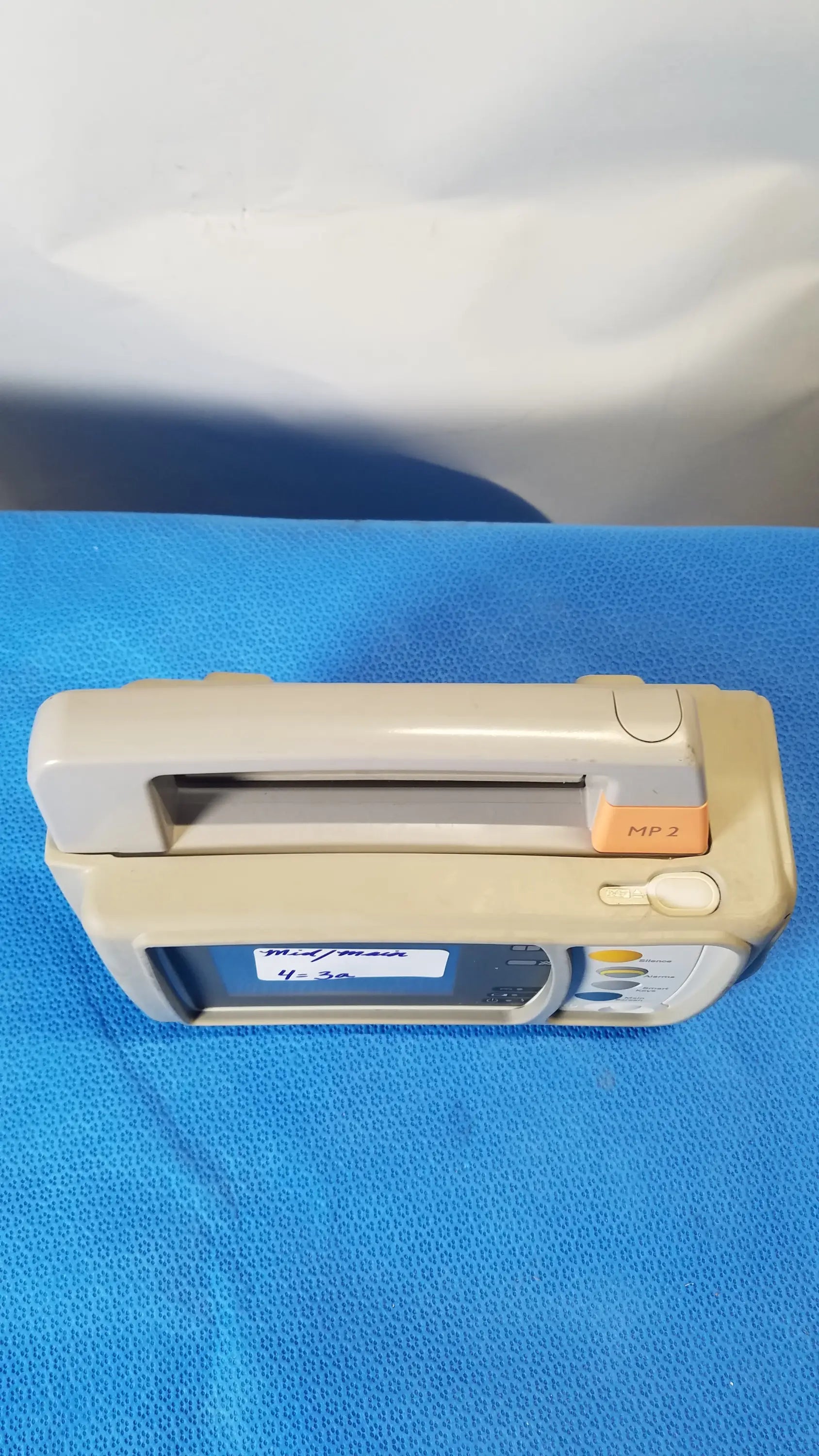 Beige and orange medical infusion pump with digital display in philips intellivue mp2 portable patient monitor medical equipment