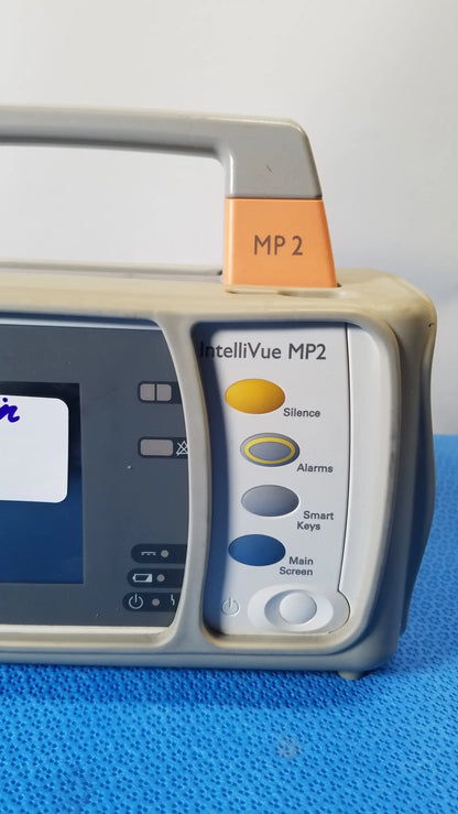 Philips intellivue mp2 portable medical equipment gray and beige monitor with handle and color-coded circular buttons