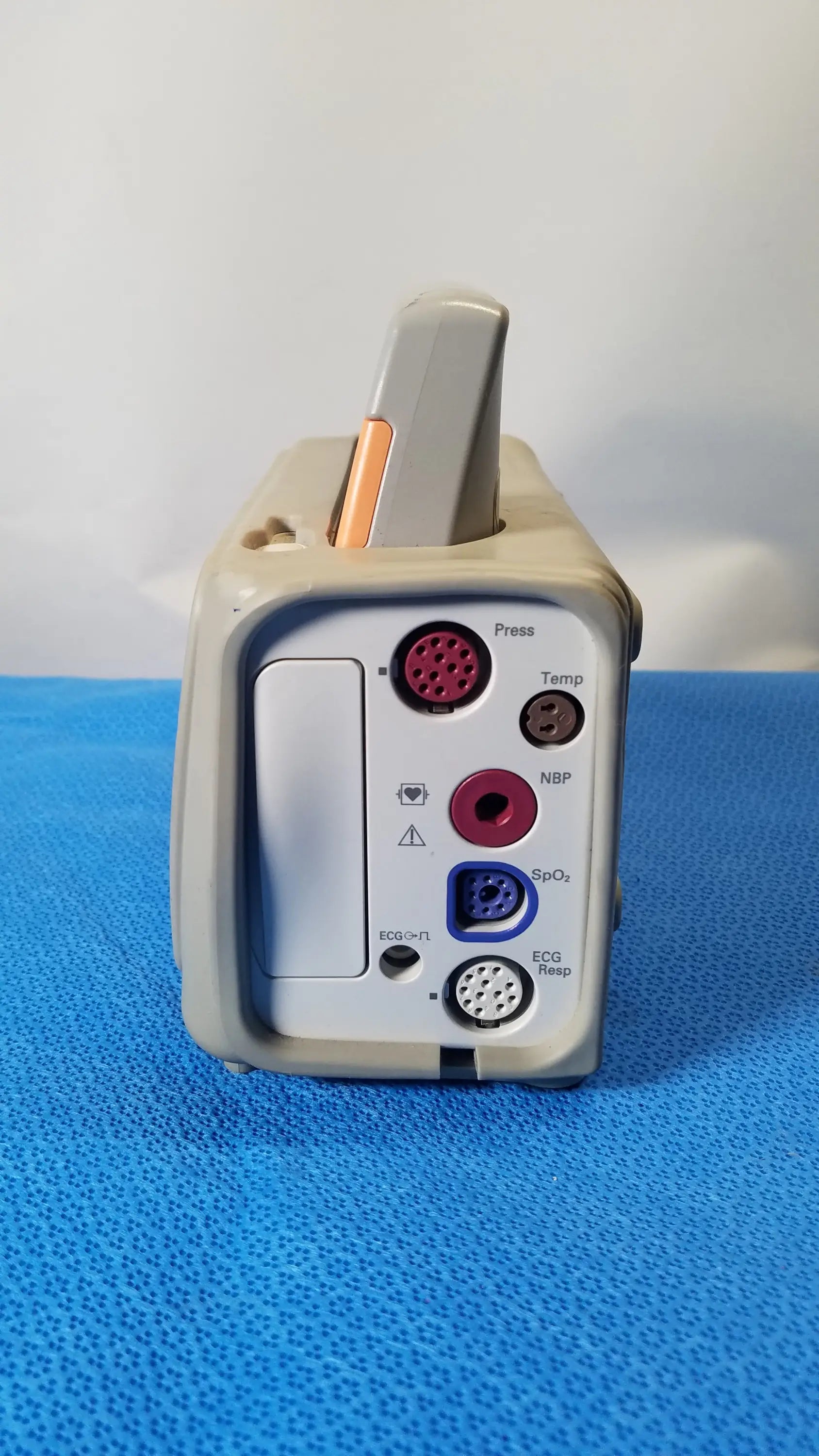 Gray philips intellivue mp2 portable patient monitor with multiple colored ports and handle visible from the back side