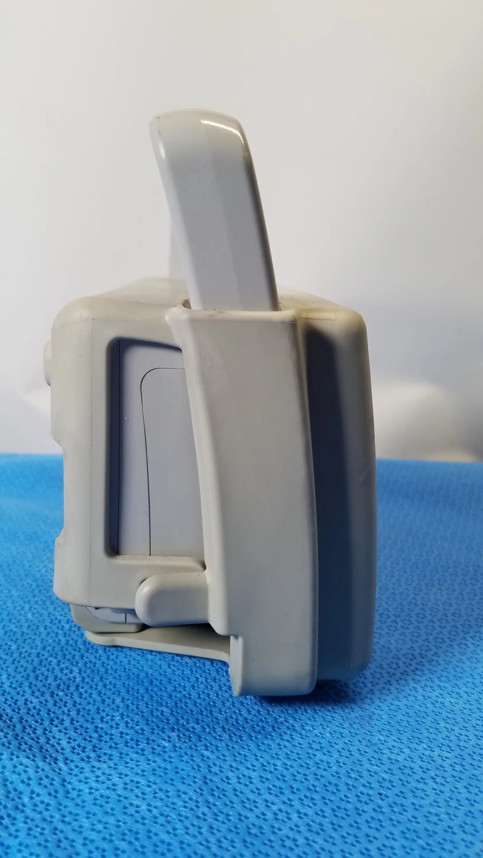 Gray plastic philips intellivue mp2 portable patient monitor with rectangular body and integrated handle for medical equipment use