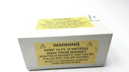 White rectangular Philips Invivo mri AC adapter AS201 with two yellow magnetic safety warning labels on the back side