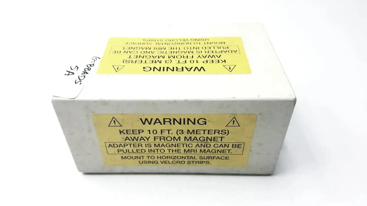 White rectangular Philips Invivo adapter as201 mri ac adapter with yellow warning labels showing mri safety precautions