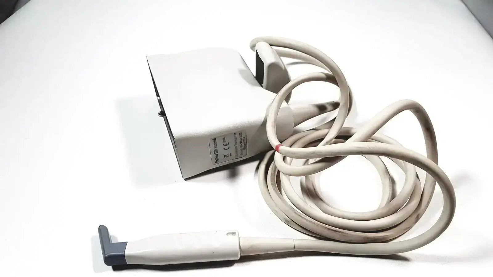 Beige Philips L15-7io linear array ultrasound transducer probe with coiled cable and gray handle end for iU22