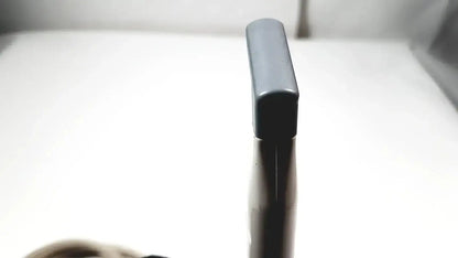 Black plastic spray bottle with rectangular nozzle cap shown alongside philips l15-7io linear array ultrasound transducer probe for iu22