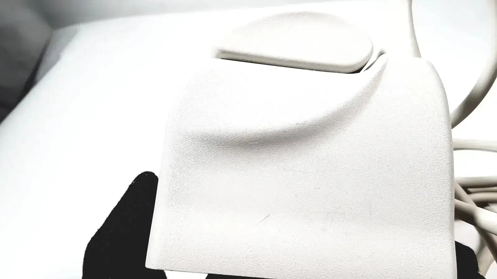White textured leather wallet with smooth rounded flap closure shown with philips l17-5 linear array ultrasound transducer probe