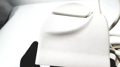 White textured leather wallet with smooth rounded flap closure shown with philips l17-5 linear array ultrasound transducer probe