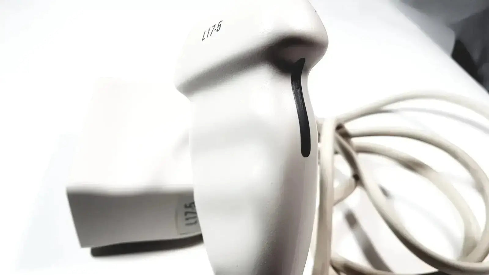 White handheld Philips L17-5 ultrasound transducer probe with black grip line and l175 model number printed on its side
