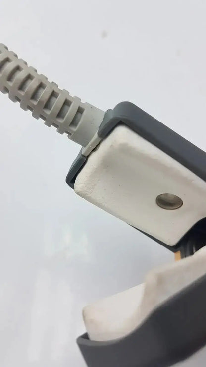Gray coiled cable connected to black and white plastic connector of philips m1196t reusable adult spo2 clip sensor